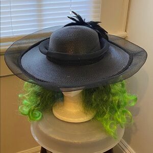 The church style straw hat black with feathers decor